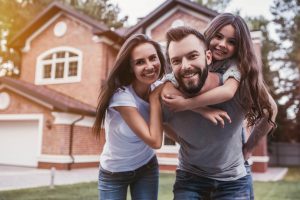 Family in front of a new house
